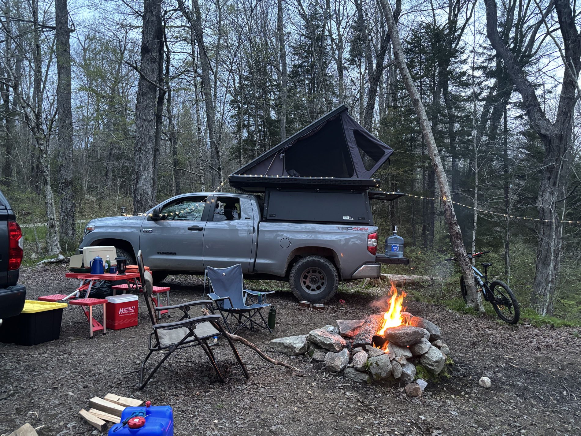 Four-season pop-up tent deployed on truck cap