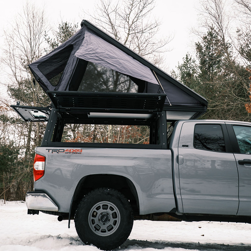 Toyota Tundra pop-up truck bed camper with mountain backdrop